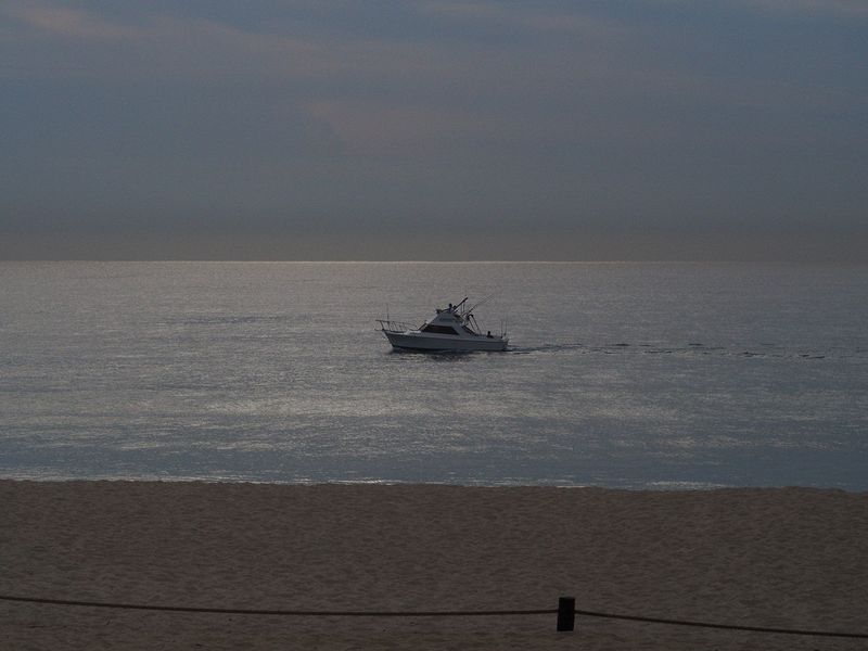 A fishing boat right next to the beach